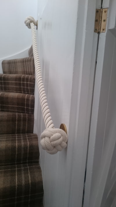 Wound cotton stair rope with antique brass finished wrought iron fittings